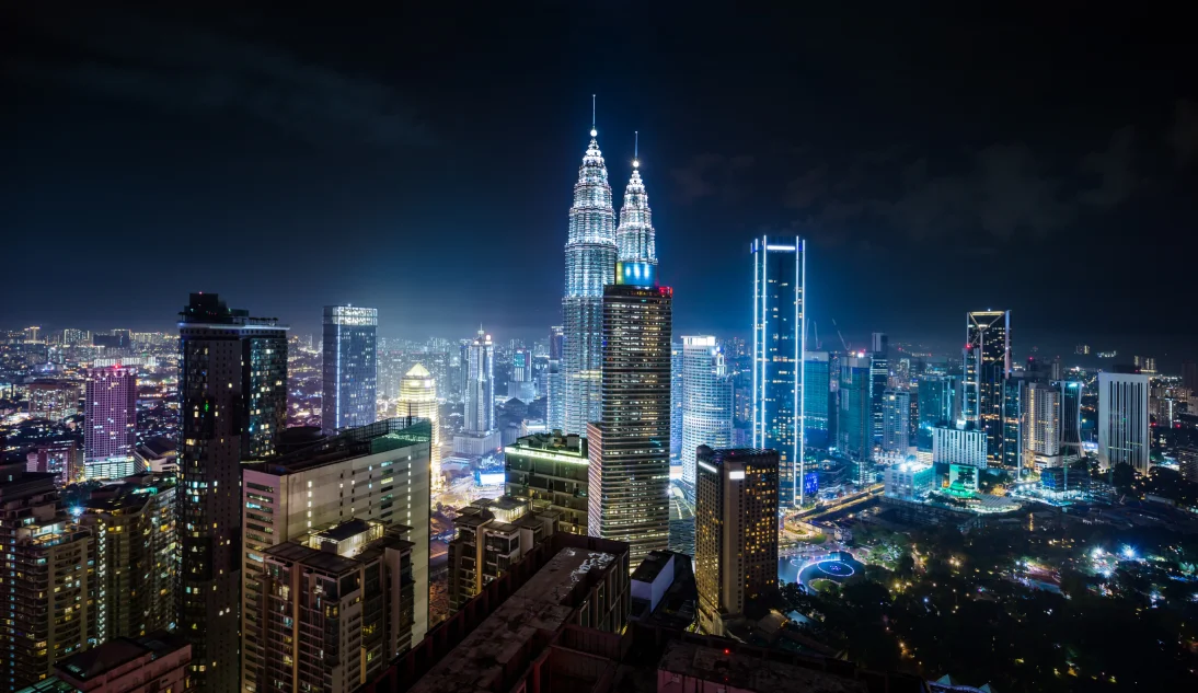 Night view of Kuala Lumpur City Centre with the illuminated Petronas Twin Towers and skyline, seen near a KL hotel near KLCC.
