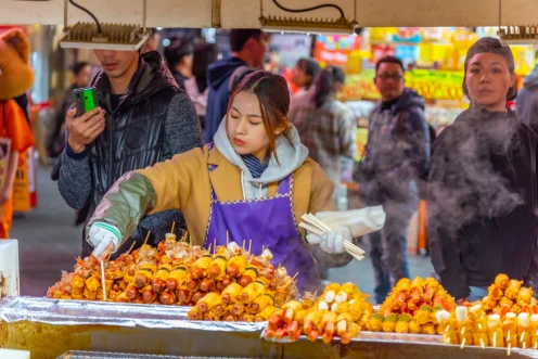 a local selling authentic Korean street food in Myeongdong, Seoul