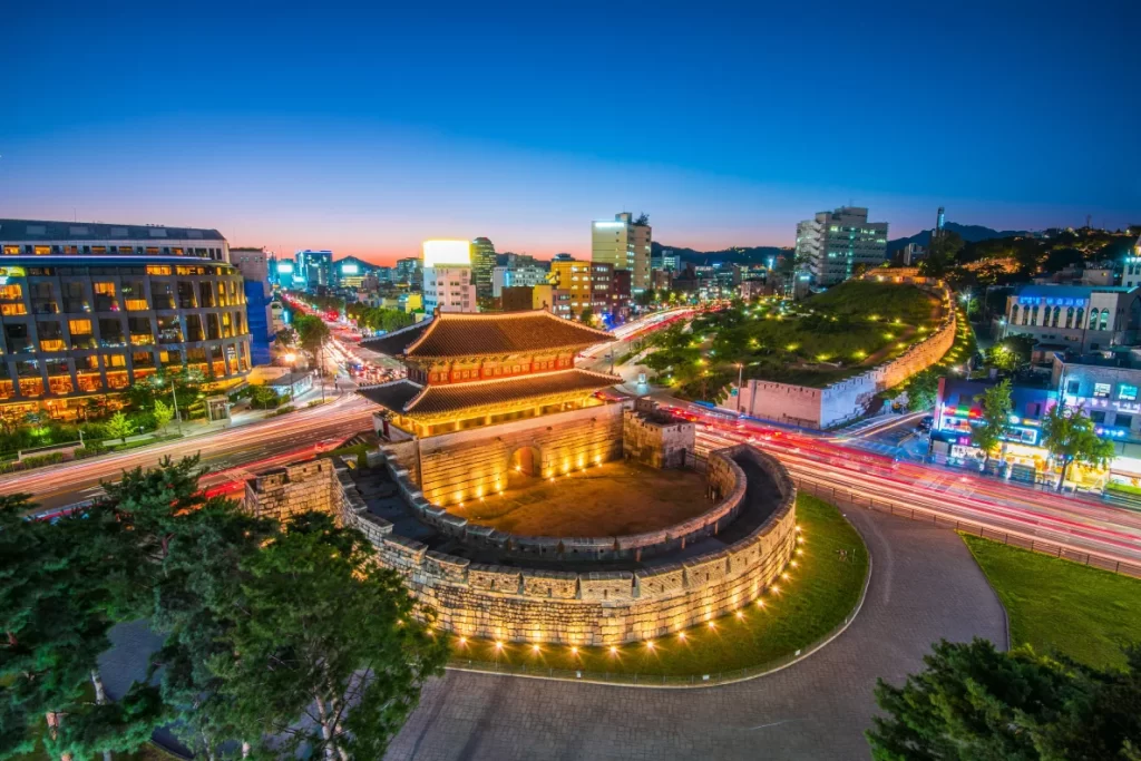 Long exposure shot of Dongdaemun Palace against the urban backdrop of Seoul