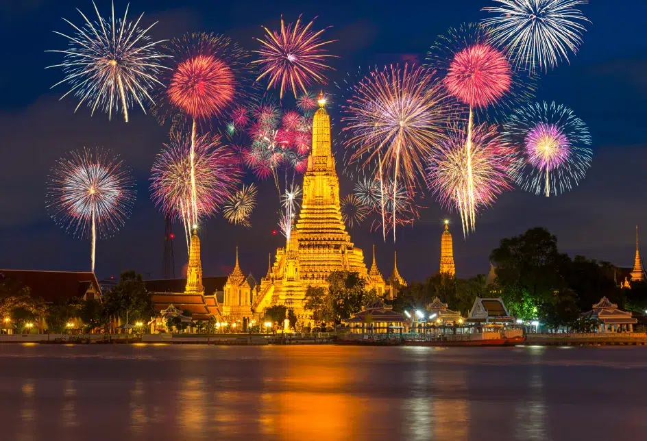 Fireworks over the horizon of the Chao Phraya River ring in the new year