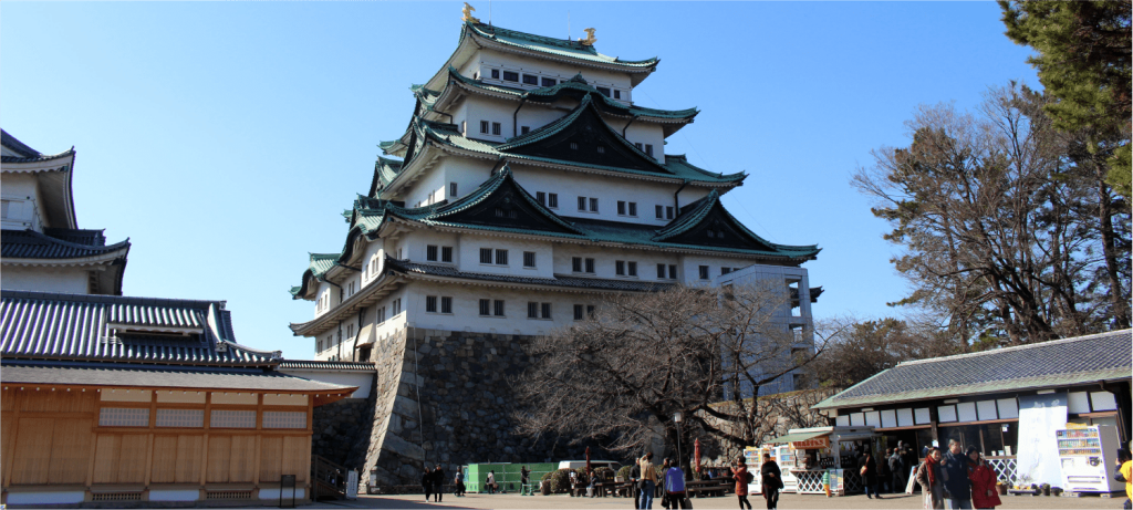Nagoya Castle in Japan with traditional Edo-style architecture and visitors exploring the historic site near central Nagoya hotels.