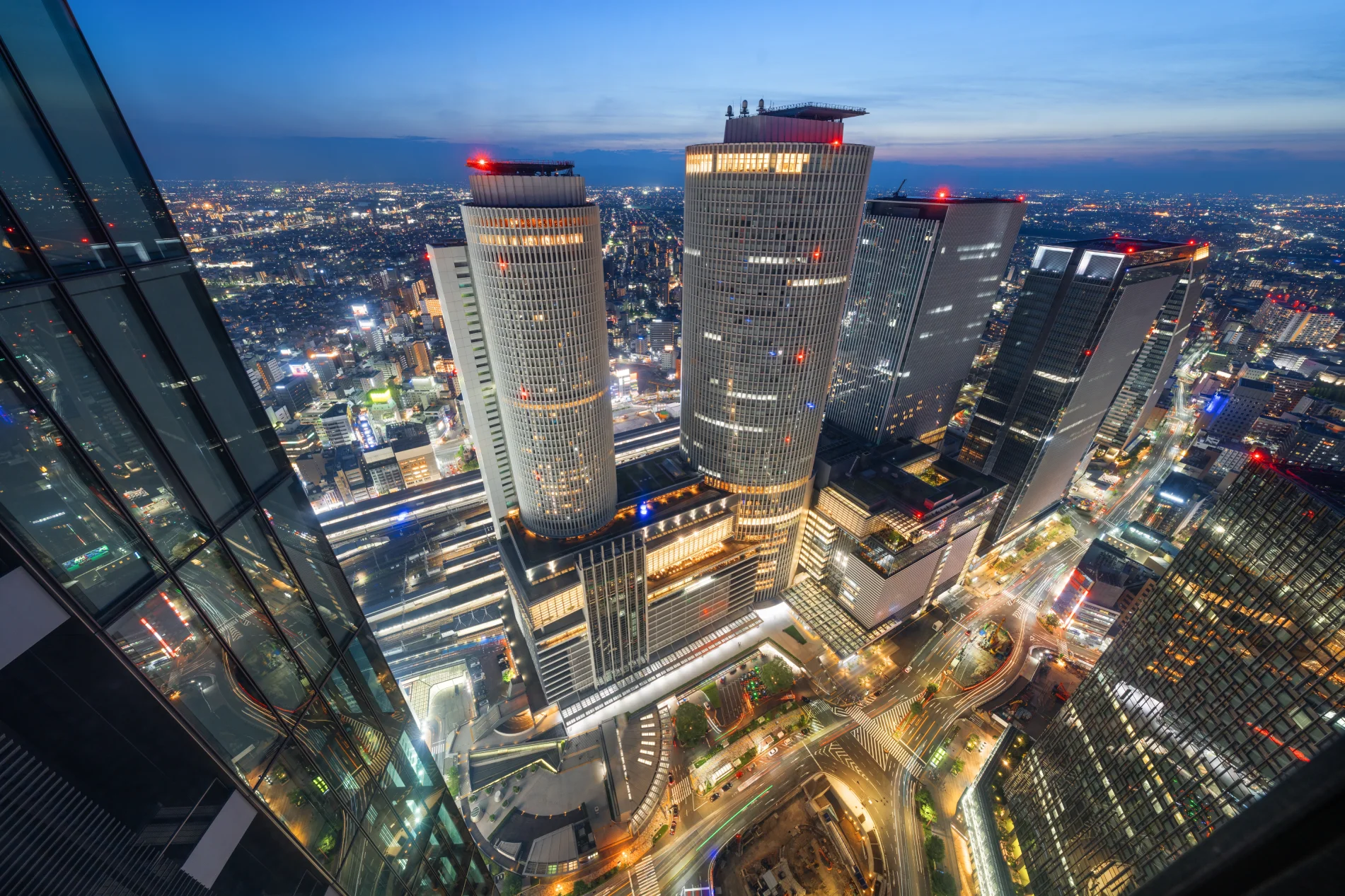 Nagoya Japan downtown cityscape near Nagoya Station with high-rise towers at twilight, ideal view for central 名古屋 ホテル staycation.