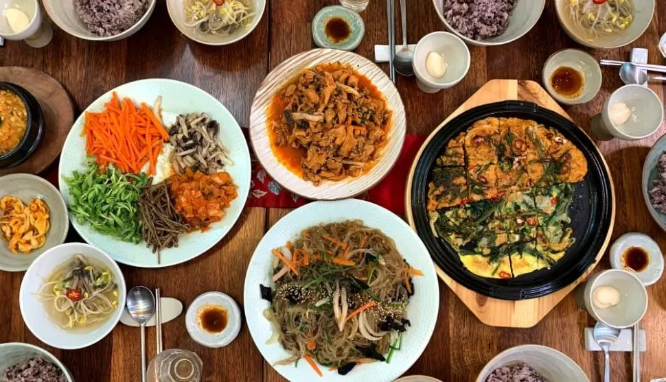 Traditional Korean dishes including japchae, pajeon, and side dishes served near 明洞 ホテル restaurants in Seoul