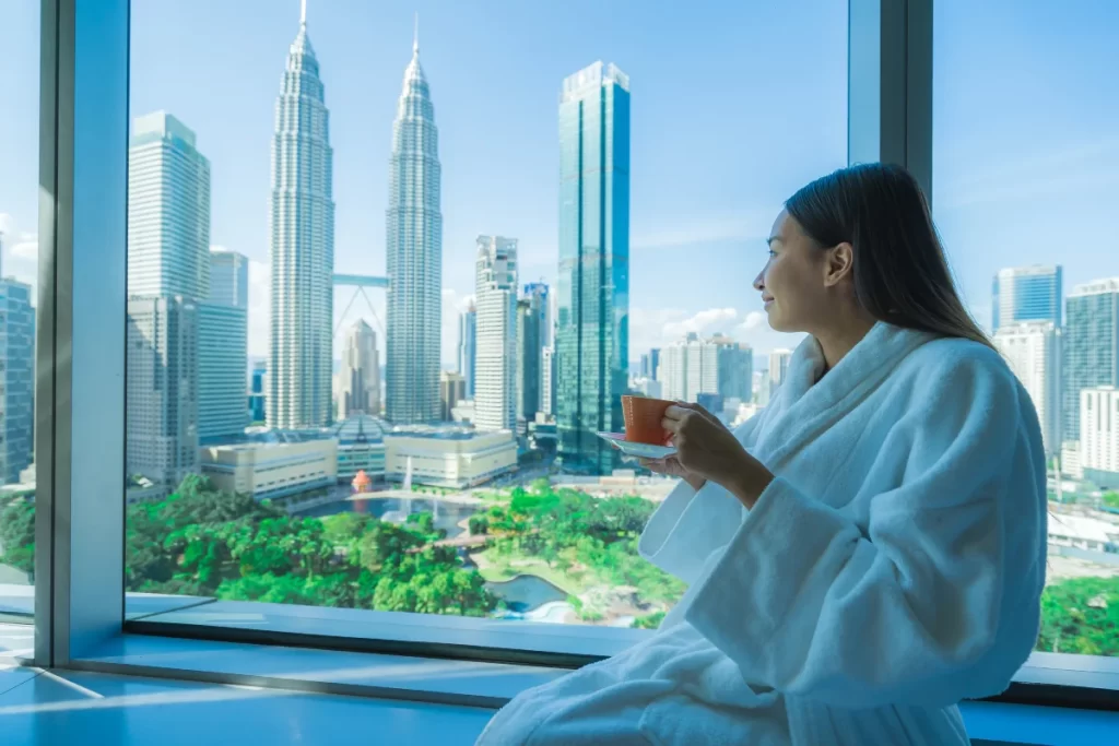 young woman enjoying her coffee in her Malaysia Hotel